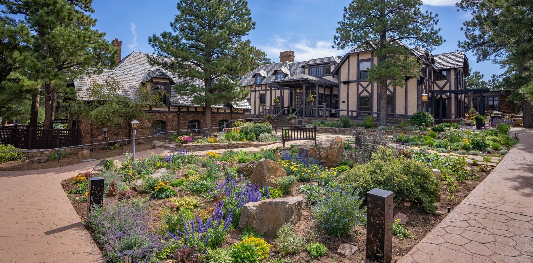 Boettcher Mansion and its flower gardens on a sunny day