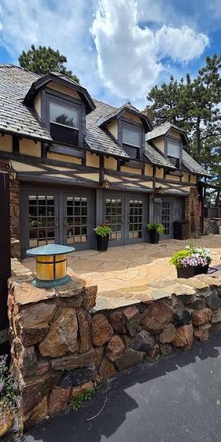 Timber-framed building beside a stone patio